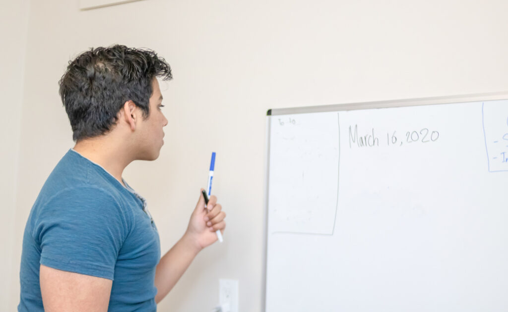 Male student looking at white board